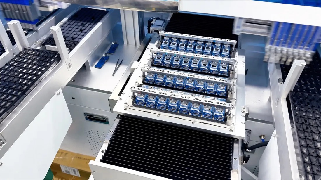 Blue flash-storage circuit boards secured in a production fixture during automated processing