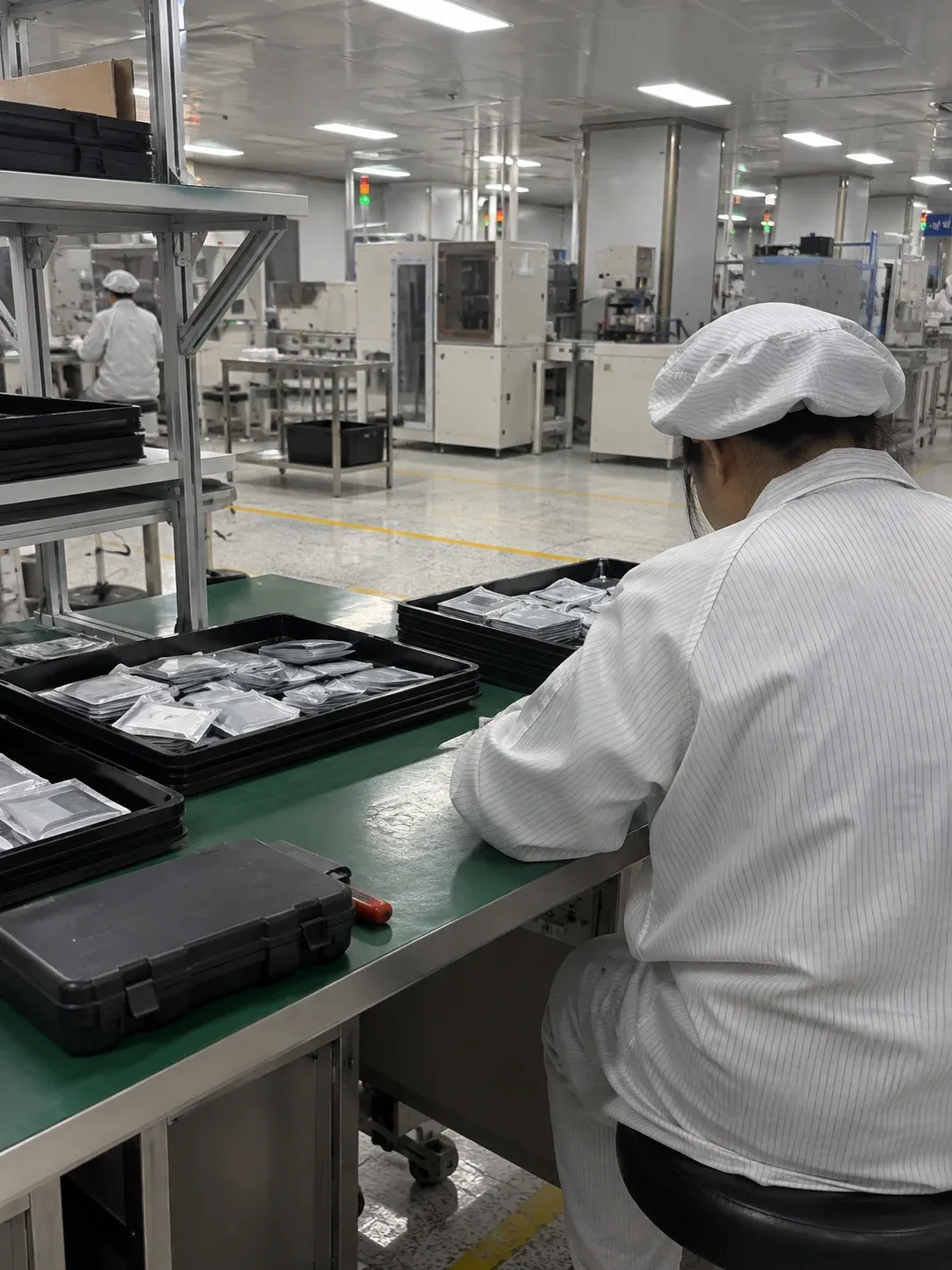 AI-generated packaging-workbench illustration, not an actual factory photograph or firmware update record